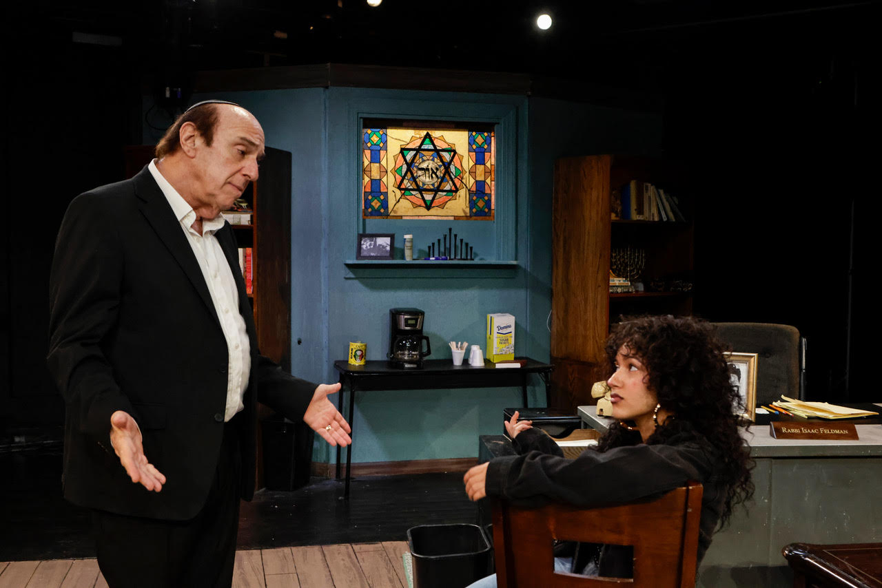 unnamed-5 Actor seated at a desk writing on documents during a scene from Kaddish for the Barrio.